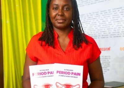 Image of Althea Reid holding Period Pain Book at NLJ